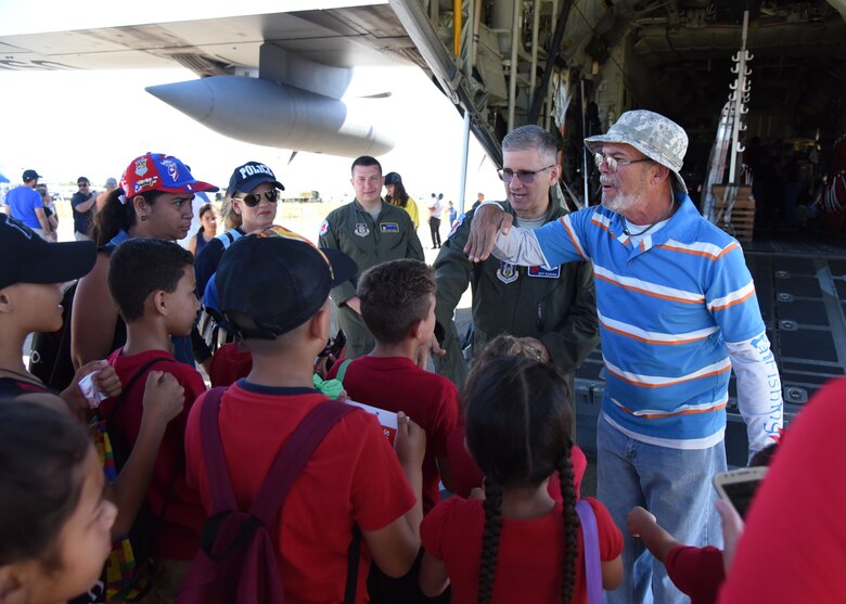Carlos A. Graulau, Puerto Rico Emergency Management Agency Zone 4 volunteer, translates for Lt. Col. Jeff Ragusa, Air Force Reserve 53rd Weather Reconnaissance Squadron pilot and aircraft commander, during the Caribbean Hurricane Awareness Tour at the Rafael Hernández Airport, Aguadilla, Puerto Rico, April 13, 2019. NOAA hurricane specialists and the U.S. Air Force Reserve Hurricane Hunters discussed hurricane preparedness, resilience and how they can become “weather-ready” during the 2019 Caribbean Hurricane Awareness Tour April 8-13, 2019. As part of the event, dignitaries, students and the public toured the Air Force Reserve Command’s WC-130J “Hurricane Hunter” aircraft to learn how scientists collect hurricane information. (U.S. Air Force photo/Lt. Col. Marnee A.C. Losurdo)