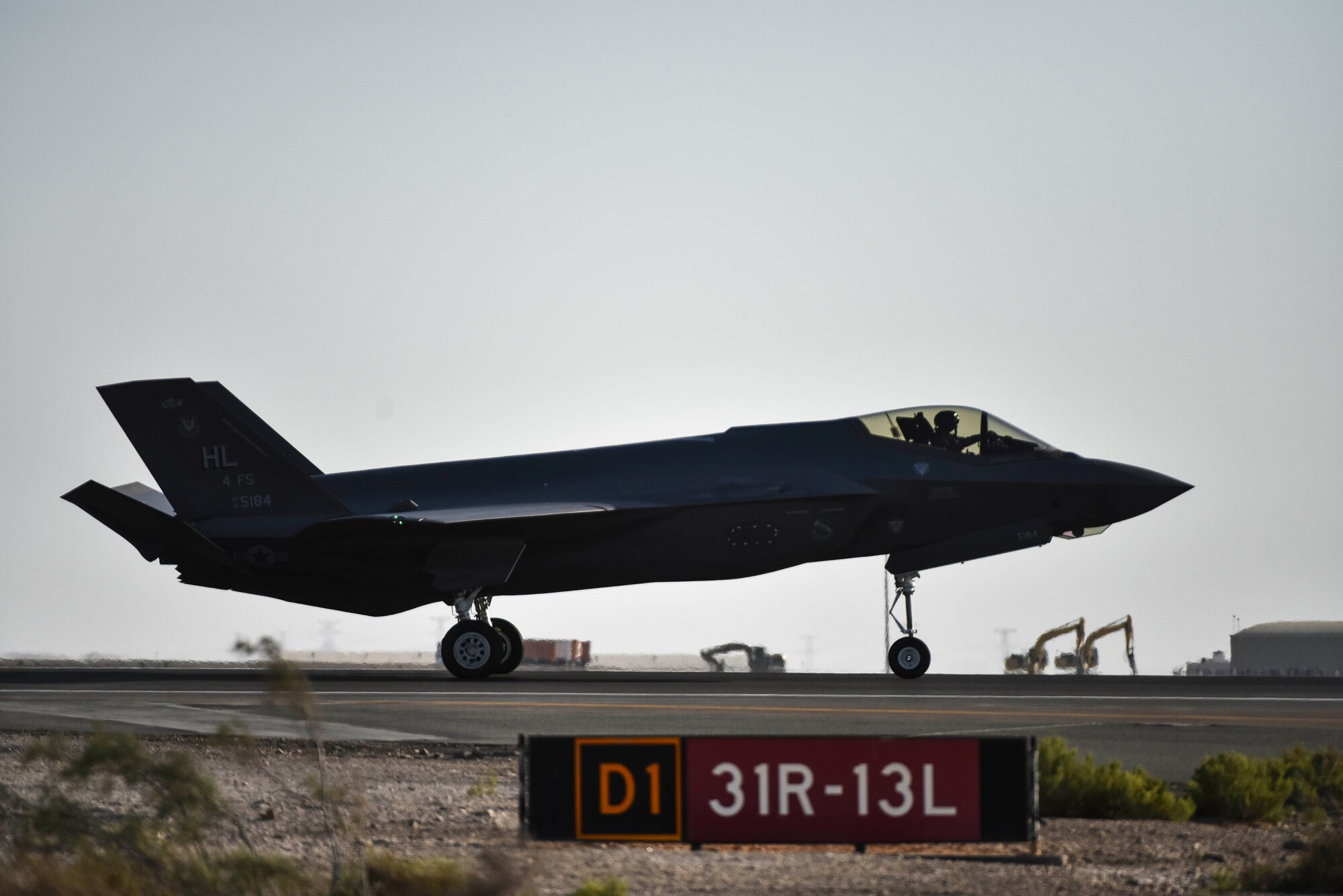 A photo of an F-35A Lightning II taxing down a runway