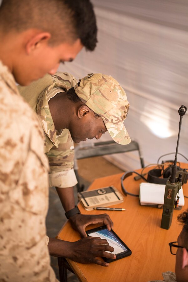 U.S. Air Force Senior Airman Demarcus Harrison, a joint terminal attack controller with 2nd Air Support Operations Squadron, uses an Android Tactical Assault Kit while instructing a class to Marines with 4th Air Naval Gunfire Liaison Company, Force Headquarters Group, Marine Forces Reserve, during exercise African Lion 2019 at the Aoreora range near Tan Tan, Morocco, March 27, 2019. African Lion is an annual, multinational, joint-force exercise designed to improve interoperability and mutual understanding of each nation’s tactics, techniques and procedures while demonstrating a strong partnership between nation’s militaries. (U.S. Marine Corps photo by Cpl. Tessa D. Watts)