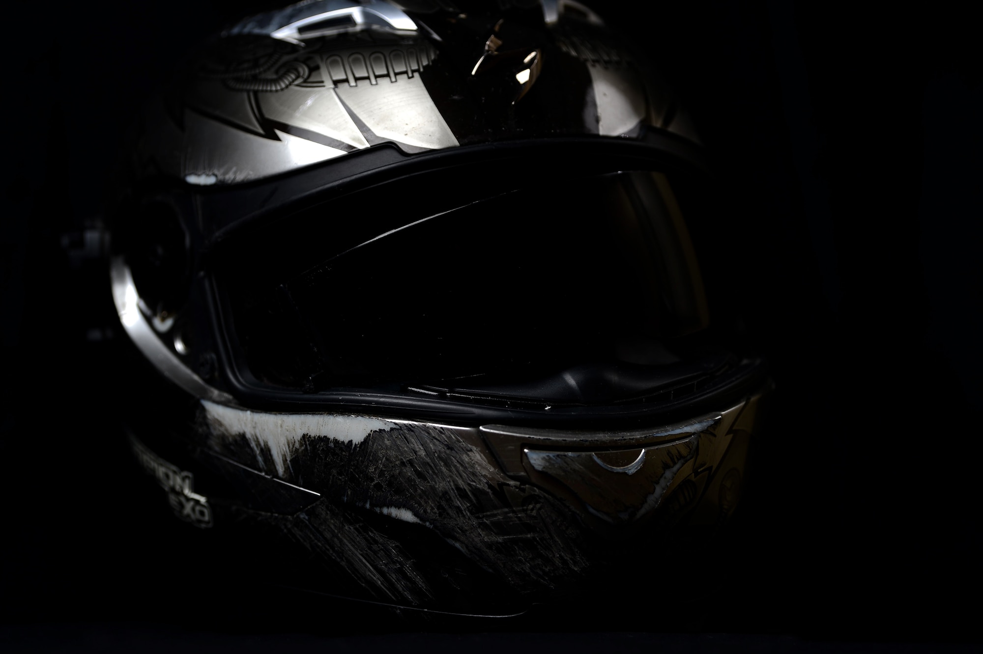 Maj. Travis, deputy of the 432nd Wing Staff Agency Commander’s Action Group and survivor of an almost deadly motorcycle accident, kept the helmet that many family and friends have said saved his life. The helmet displays a blown out visor, scratches on the exterior and can now be compressed with little effort. (U.S. Air Force photo by Airman 1st Class Haley Stevens)