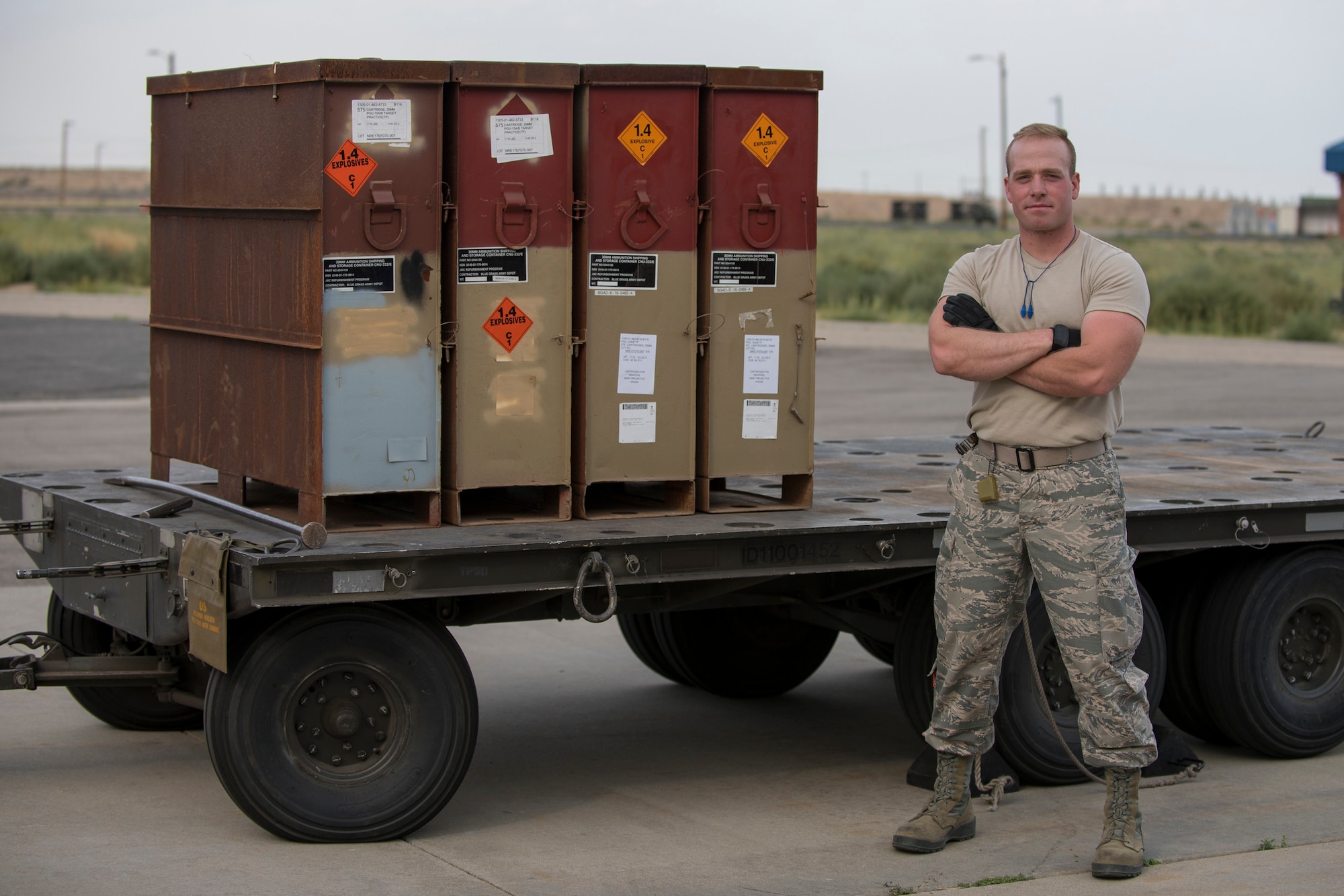 Airman 1st Class Isaac M. Campbell, a munitions systems apprentice from the 124th Maintenance Squadron, 124th Fighter Wing, stands next to boxes of 30 mm ammunition at Gowen Field, Idaho, Aug. 17, 2018.