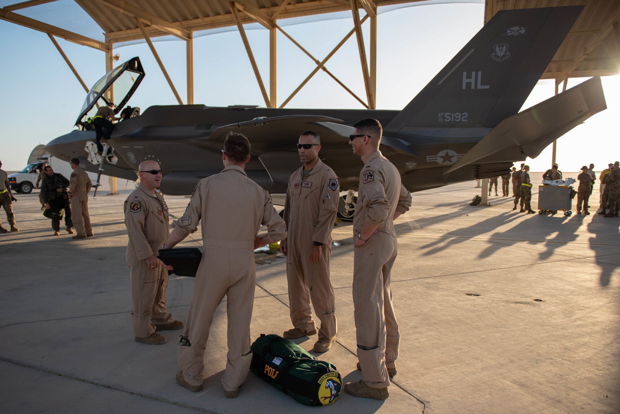 A photo of service members having a conversation next to an F-35A Lightning II