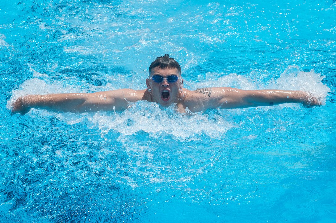 A Marine swims in a relay.