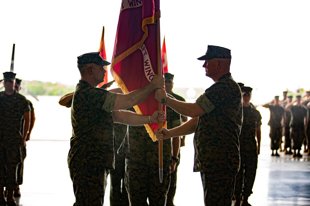 U.S. Marine Corps Maj. Gen. Bradley S. James, right, commander of Marine Forces Reserve, Marine Forces North and 4th Marine Aircraft Wing, passes the 4th MAW colors to Brig. Gen. Timothy L. Adams, member of the Marine Corps Reserve Policy Board, during the 4th MAW change of command ceremony at Naval Air Station Joint Reserve Base New Orleans, April 13, 2019. The ceremony was held to recognize the formal transfer of authority and responsibilities of 4th MAW from James to Adams. (U.S. Marine Corps photo by Lance Cpl. Jose Gonzalez)