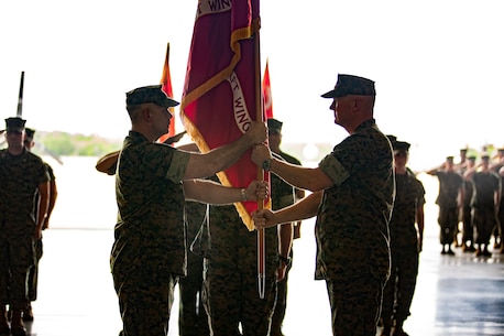U.S. Marine Corps Maj. Gen. Bradley S. James, right, commander of Marine Forces Reserve, Marine Forces North and 4th Marine Aircraft Wing, passes the 4th MAW colors to Brig. Gen. Timothy L. Adams, member of the Marine Corps Reserve Policy Board, during the 4th MAW change of command ceremony at Naval Air Station Joint Reserve Base New Orleans, April 13, 2019. The ceremony was held to recognize the formal transfer of authority and responsibilities of 4th MAW from James to Adams. (U.S. Marine Corps photo by Lance Cpl. Jose Gonzalez)