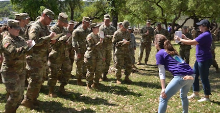 Members of the 549th Military Intelligence Battalion participate in an exercise in which they marched in place while answering questions at the same time. The exercise was one of several interactive activities service members participated in at a resiliency event on Joint Base San Antonio-Camp Bullis conducted by the Vogel Resiliency Center April 12.