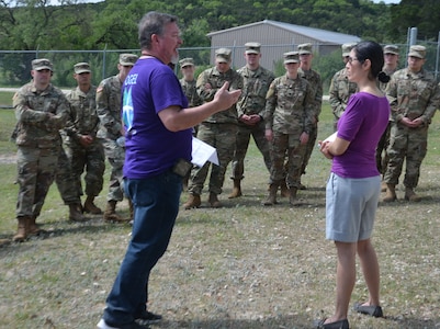 John Rangel, Military and Family Life counselor (left), and Geremy Chavez (right), personal financial counselor, act in a skit about a military couple dealing with financial issues in front of members of the 549th Military Intelligence Battalion. The skit was one of several interactive activities and presentations for service members at a resiliency event on Joint Base San Antonio-Camp Bullis conducted by the Vogel Resiliency Center April 12.