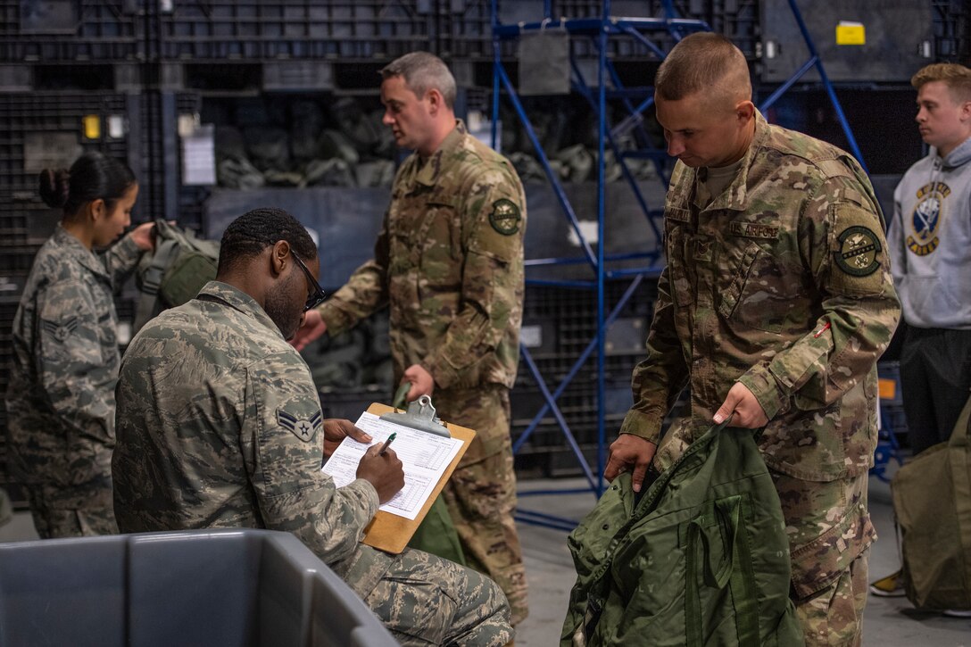 Airmen receive their MOPP gear April, 2, 2019, at Moody Air Force Base, Ga. From April 15-19, 2019, Moody executed a base-wide exercise that required players to function at a high operations tempo in a chemical, biological, radioactive and nuclear environment to meet Chief of Staff of the Air Force and the Commander of Air Combat Command’s intent for readiness. (U.S. Air Force photo by Airman 1st Class Joseph P. Leveille)