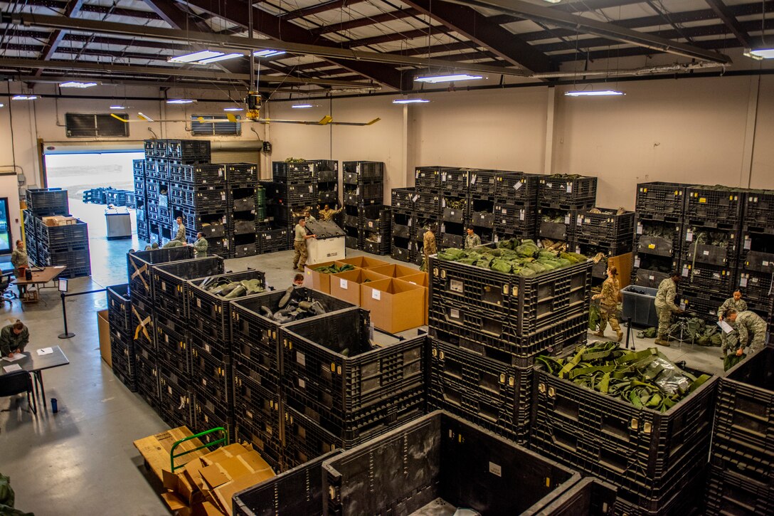 Airmen pick up gear April 2, 2019, at Moody Air Force Base, Ga. From April 15-19, 2019, Moody executed a base-wide exercise that required players to function at a high operations tempo in a chemical, biological, radioactive and nuclear environment to meet Chief of Staff of the Air Force and the Commander of Air Combat Command’s intent for readiness. (U.S. Air Force photo by Airman 1st Class Joseph P. Leveille)