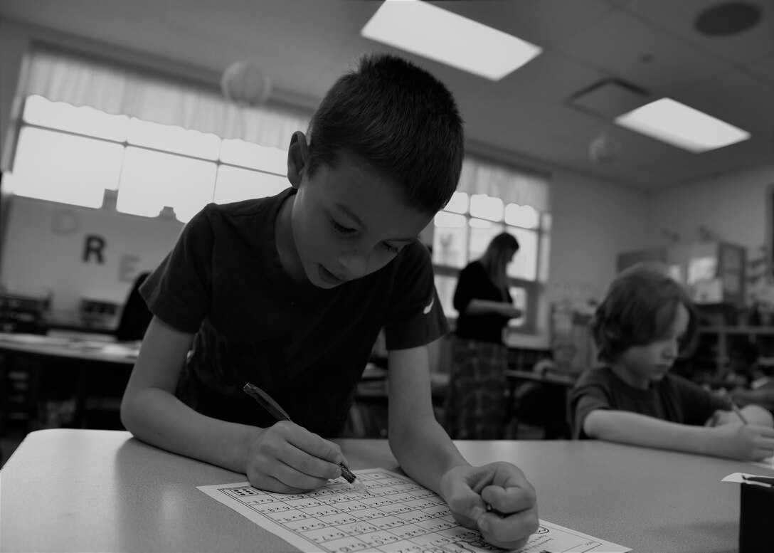 Reagan works on a math paper at school, April 15, 2019, in Cheyenne, Wyo. Reagan has adapted to the life of a military child. Purple is the color of the month of the military child, family and friends of military kids wear purple to show their support of the sacrifices and difficulties they face. (U.S. Air Force photo by Airman 1st Class Braydon Williams)
