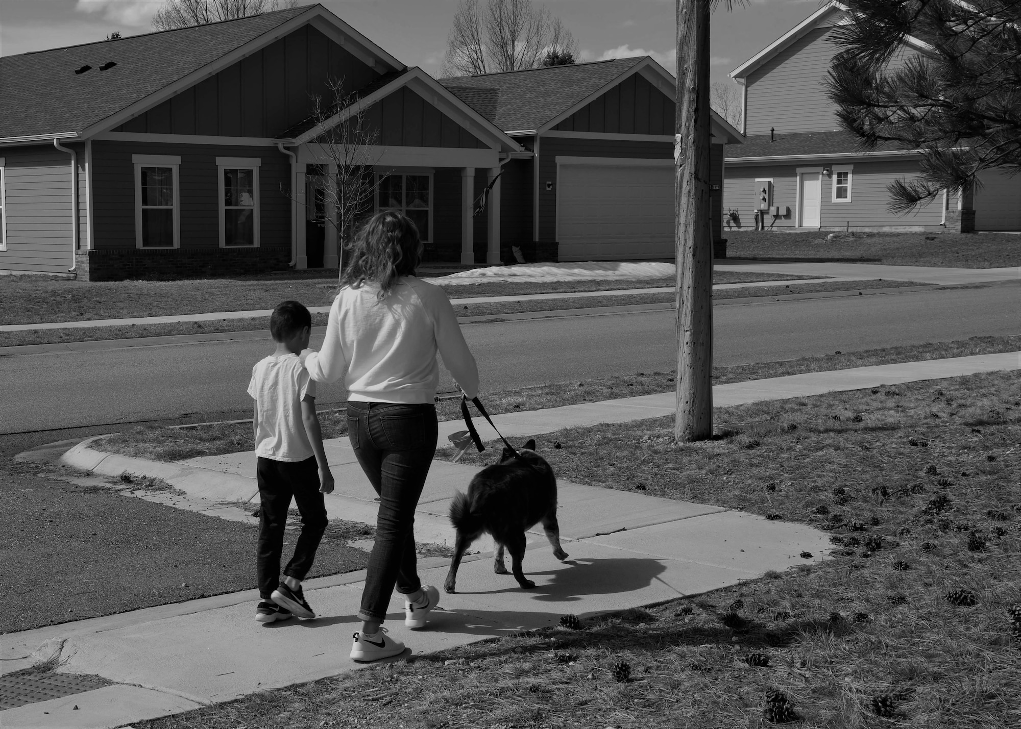 Airman 1st Class Megan Melvin, 90th Communications Squadron knowledge operations, and her son, Reagan walk home with their dog toby, April 6, 2019, on F.E. Warren Air Force Base, Wyo. The life of a military kid isn’t easy but they always make the best of what they have, the Month of The Military Child gives military children the chance look at their own life and talk about what they face as a military child. (U.S. Air Force photo by Airman 1st Class Braydon Williams)