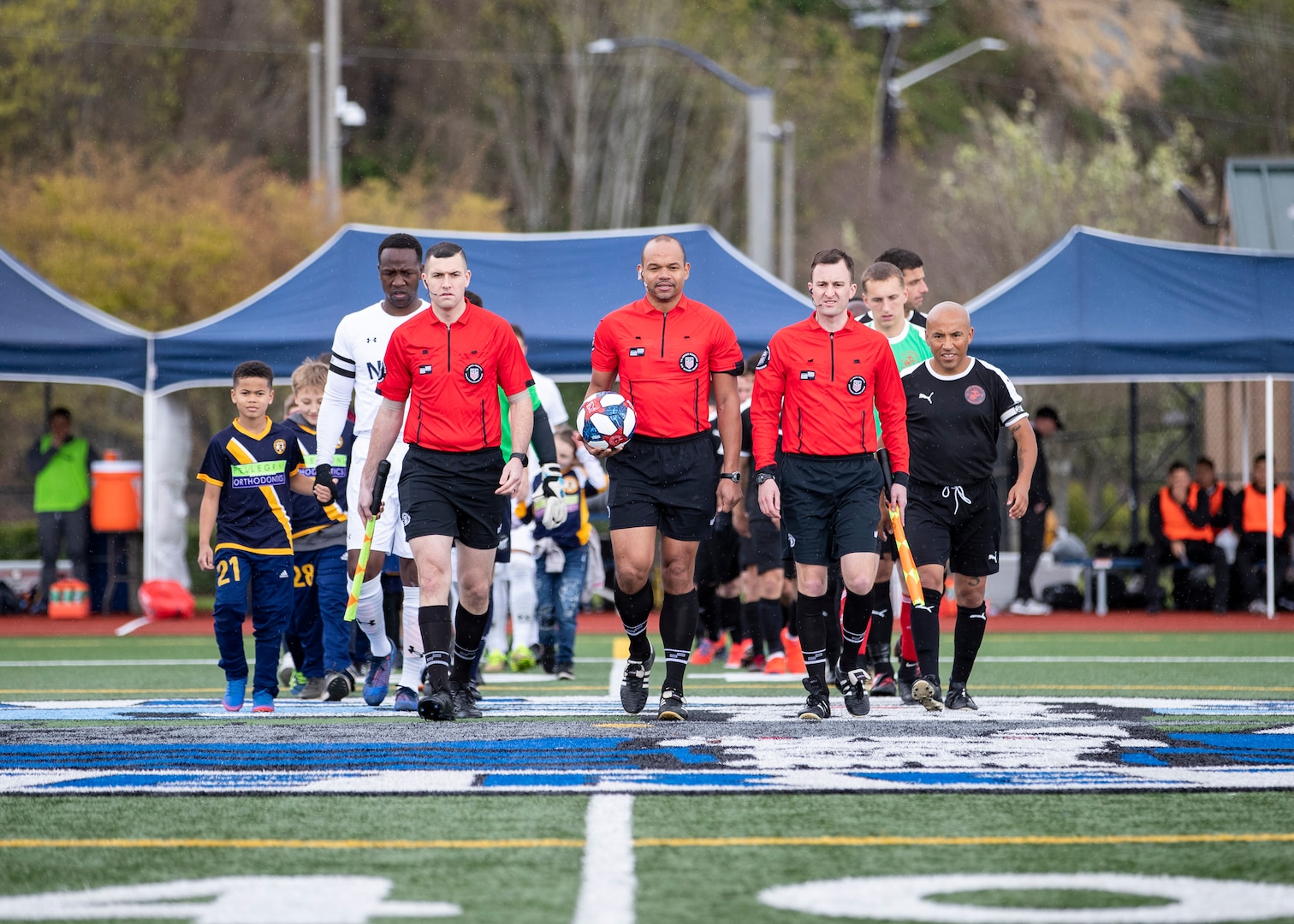 NAVAL STATION EVERETT, Wa. (April 14, 2019) - Navy and Marein Corp. soccer teams head on to the field for day one of the 2019 Armed Forces Men's Soccer Championship hosted at Naval Station Everett, Wa. from 14-20 April, featuring Service members from the Army, Marine Corps, Navy (including Coast Guard) and Air Force. (U.S. Navy Photo by Mass Communicaton Specialist 2nd Class Ian Carver/RELEASED).