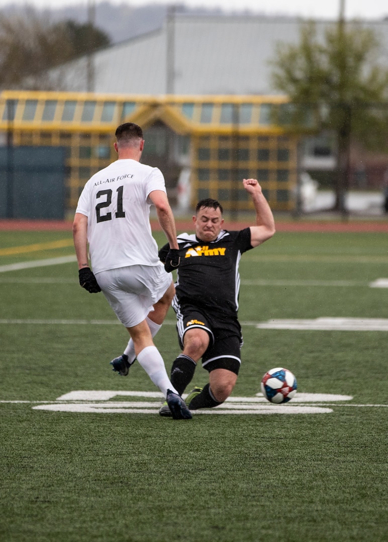 NAVAL STATION EVERETT, Wa. (April 14, 2019) - Capt. Andy Hyres, stationed at Joplin, Mo. slides to take the ball from Airman 1st Class Austin Spagnola, stationed at Joint Base Lewis McChord, Wa., during the first round of the Armed Forces Sports Men’s Soccer Championship hosted at Naval Station Everett. (U.S. Navy Photo by Mass Communication Specialist 2nd Class Ian Carver/RELEASED).  190414-N-XK513-1207