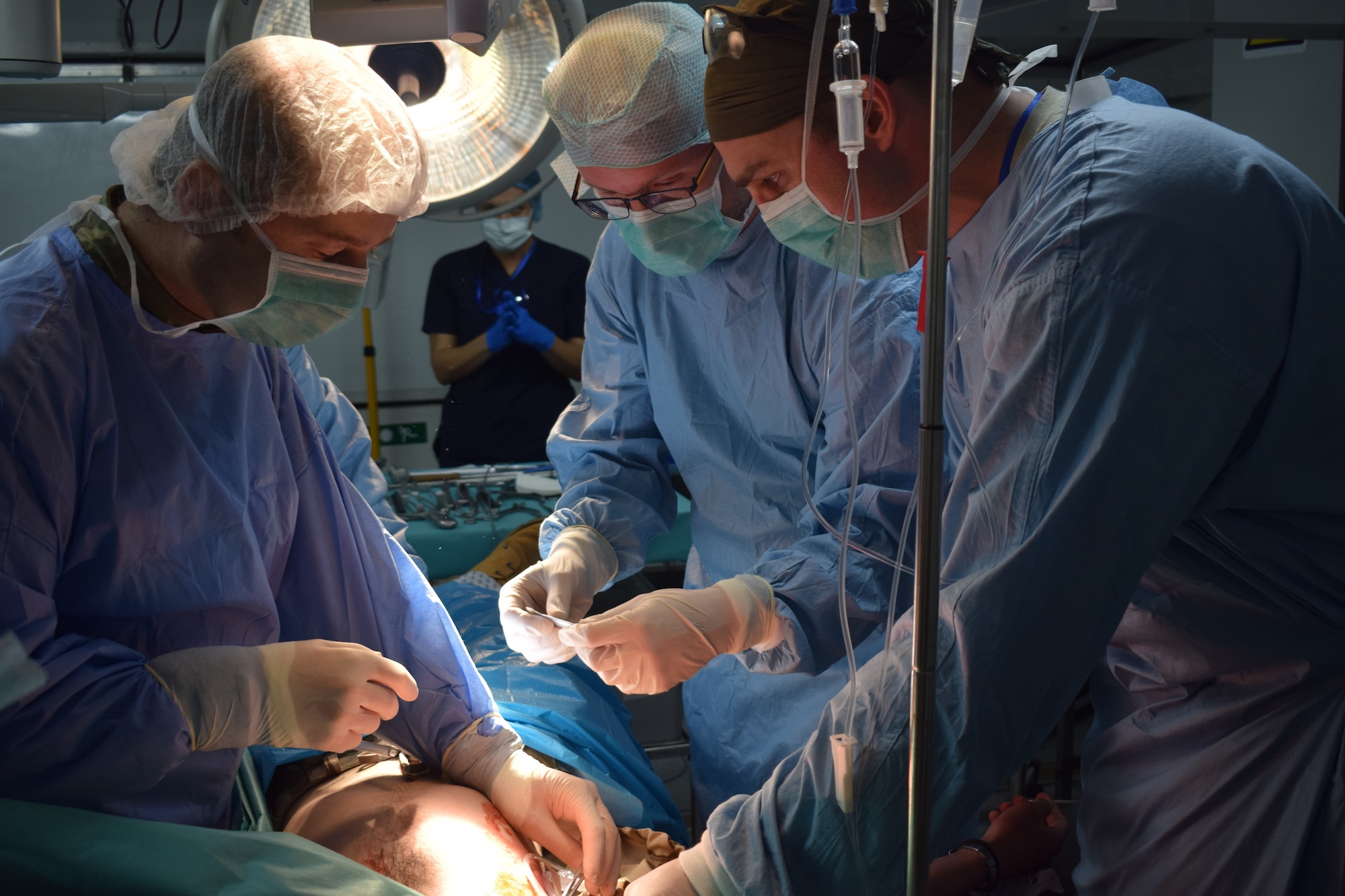 U.S. Air Force Maj. Florin Buia, general and vascular surgeon, Cluj-Napoca Emergency Military Hospital, Romania, left, Capt. Hendrik van de Krol, trauma surgeon, Royal Netherlands Navy, center, and Maj Daniel Hatz, orthopedic surgeon, 86th Medical Group, Ramstein Air Base, Germany, participate in a multinational surgical exchange drill at the Romanian Role 3 medical unit during Vigorous Warrior 19, Cincu Military Base, Romania, April 11, 2019. Vigorous Warrior 19 is NATO’s largest-ever military medical exercise, uniting more than 2,500 participants from 39 countries to exercise experimental doctrinal concepts and test their medical assets together in a dynamic, multinational environment. (U.S. Air Force photo by 1st Lt. Andrew Layton)