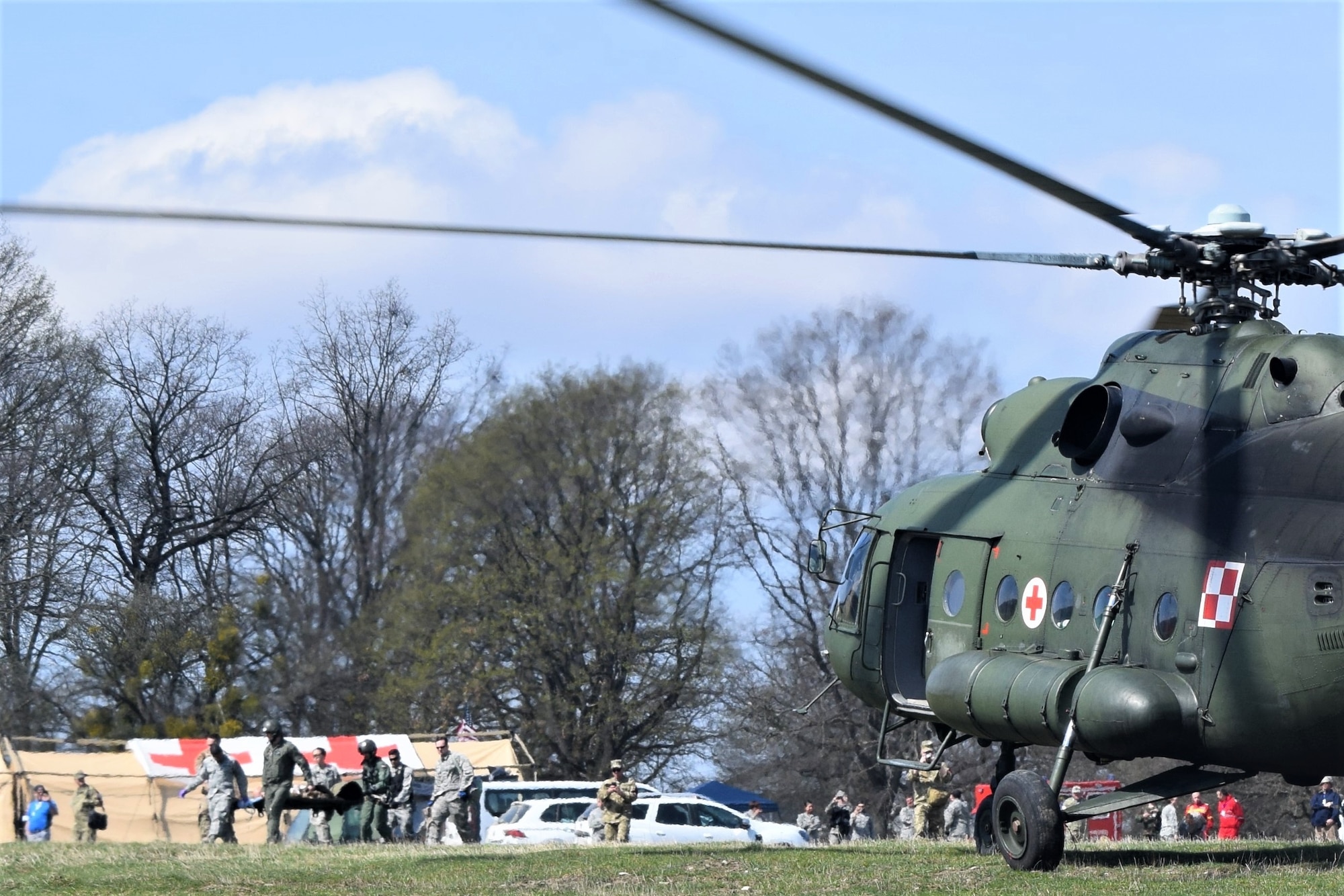 Airmen from the 86th Medical Group, Ramstein Air Base, Germany, participate in a multinational medical evacuation exercise drill with a Polish Mi-17 helicopter during Vigorous Warrior 19, Cincu Military Base, Romania, April 9, 2019. About 50 Airmen from the 86th MDG participated in Vigorous Warrior 19, NATO’s largest-ever military medical exercise. (U.S. Air Force photo by 1st Lt. Andrew Layton)