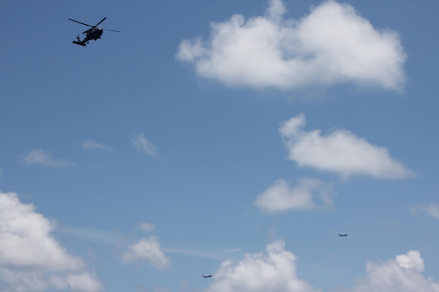 An MH-60R Sea Hawk assigned to Maritime Strike Squadron (HSM) 71, left, embarked aboard the guided-missile destroyer USS Spruance (DDG 111) conducts flight operations in the Indian Ocean as a U.S. Navy P8A Poseidon, right, and an Indian Navy P8I Poseidon conduct a low altitude fly by during a bilateral anti-submarine warfare exercise with the Indian Navy, April 15, 2019. The Spruance is deployed to the U.S. 7th Fleet area of operations in support of security and stability in the Indo-Pacific region.