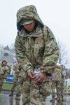Air Force Tech. Sgt. Shavonne Hinds pins a Boston Marathon race bib to her leg. She was among several Guard members who participated in the event in uniform.