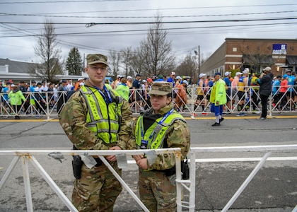 Spc. Daniel Dellisola and Pvt. Haley MacDonald, 747th Military Police Company Soldiers, support state and local law enforcement during the 123rd Boston Marathon April 15, 2019, in Hopkinton, Massachusetts. More than 500 members of the Massachusetts National Guard provided support during the marathon.