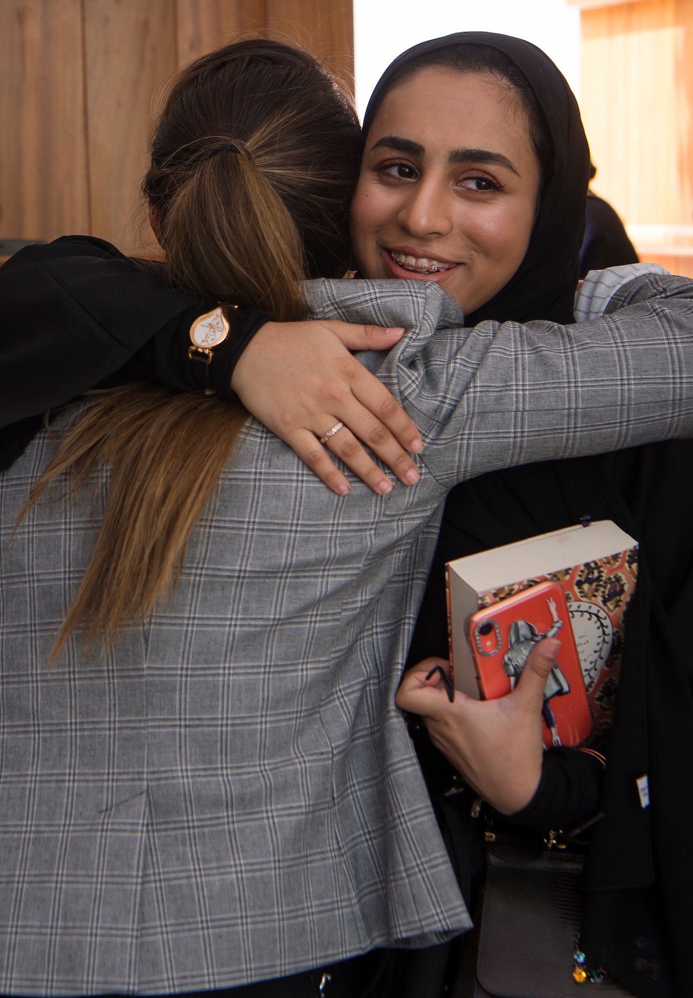 Capt. Hanna Sparks, left, 379th Air Expeditionary Wing sexual assault prevention and response coordinator, embraces Qatar Emiri Air Force Lt. Hind Bajidaph, executive officer to the Qatar Emiri Air Force commander, at the end of the second Women’s Networking Breakfast March 20, 2019, in Doha, Qatar. The event was designed to give women from both militaries the opportunity to grow personally and professionally, learn about other cultures, share military experiences, and build relationships. (U.S. Air Force photo by Tech. Sgt. Christopher Hubenthal)