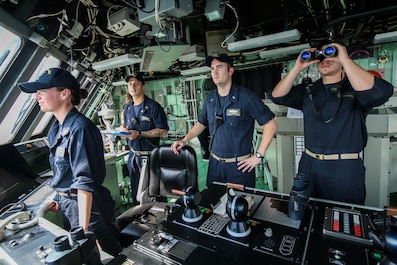 150723-N-IH037-001
SOUTH CHINA SEA (July, 23, 2015) Lt. j.g. Hasenbank, center, mentors new ensigns as he stands his last officer of the deck watch aboard the littoral combat ship USS Fort Worth (LCS 3) during a Singapore Strait transit. Hasenbank was one of the first assigned ensigns to the LCS program and the first ensign to earn a Surface Warfare Officer pin on an LCS. Currently on a 16-month rotational deployment in support of the Indo-Asia-Pacific-Rebalance, Fort Worth is a fast and agile warship tailor-made to patrol the region's littorals and work hull-to-hull with partner navies, providing the U.S. 7th Fleet with the flexible capabilities it needs now and in the future (U.S. Navy photo by Lt. James Arterberry/Released)