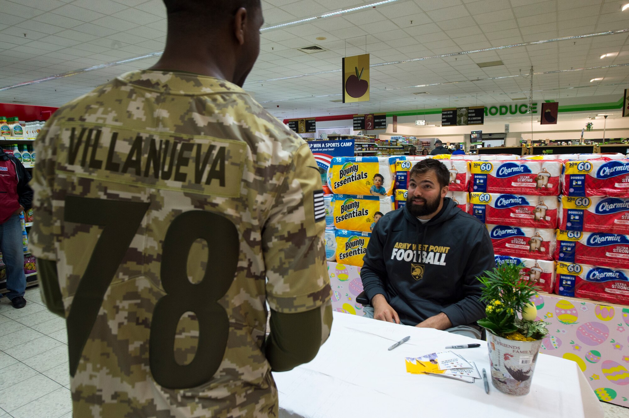 Alejandro Villanueva, Pittsburgh Steelers offensive lineman, talks to a Kaiserslautern Military Community member during an autograph session at the commissary on Vogelweh Military Complex, April 13, 2019. Villanueva, a former U.S. Army captain and Army Ranger, was awarded the Bronze Star medal with valor for his actions during a deployment to Afghanistan. (U.S. Air Force photo by Staff Sgt. Jonathan Bass)