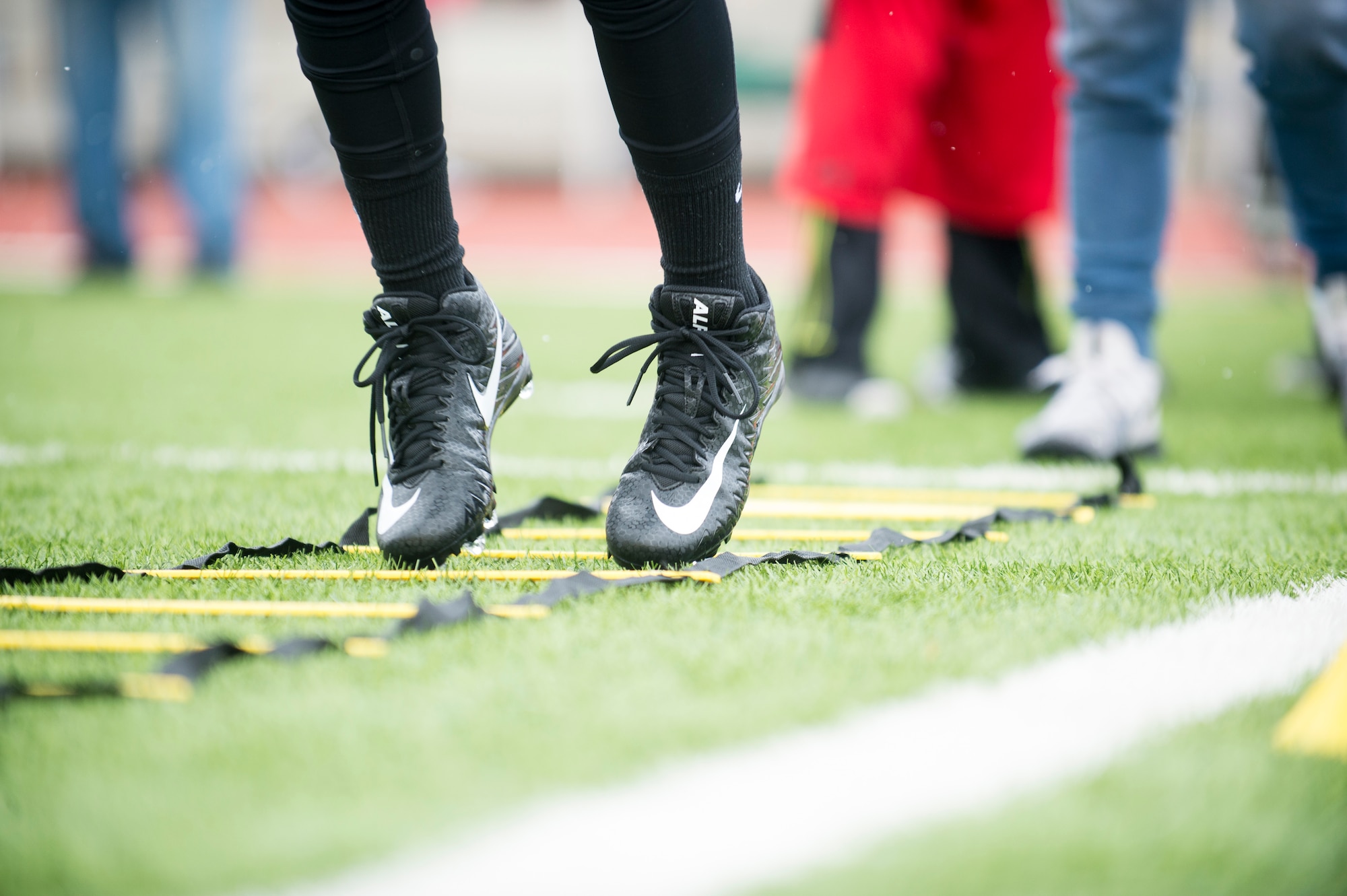 An Alejandro Villanueva football camp attendee jumps through a ladder drill during offensive drills at Kaiserslautern High School on Vogelweh Military Complex, Germany, April 13, 2019. Villanueva, Pittsburgh Steelers offensive lineman, hosted a two-day camp for Kaiserslautern Military Community youth. (U.S. Air Force photo by Staff Sgt. Jonathan Bass)