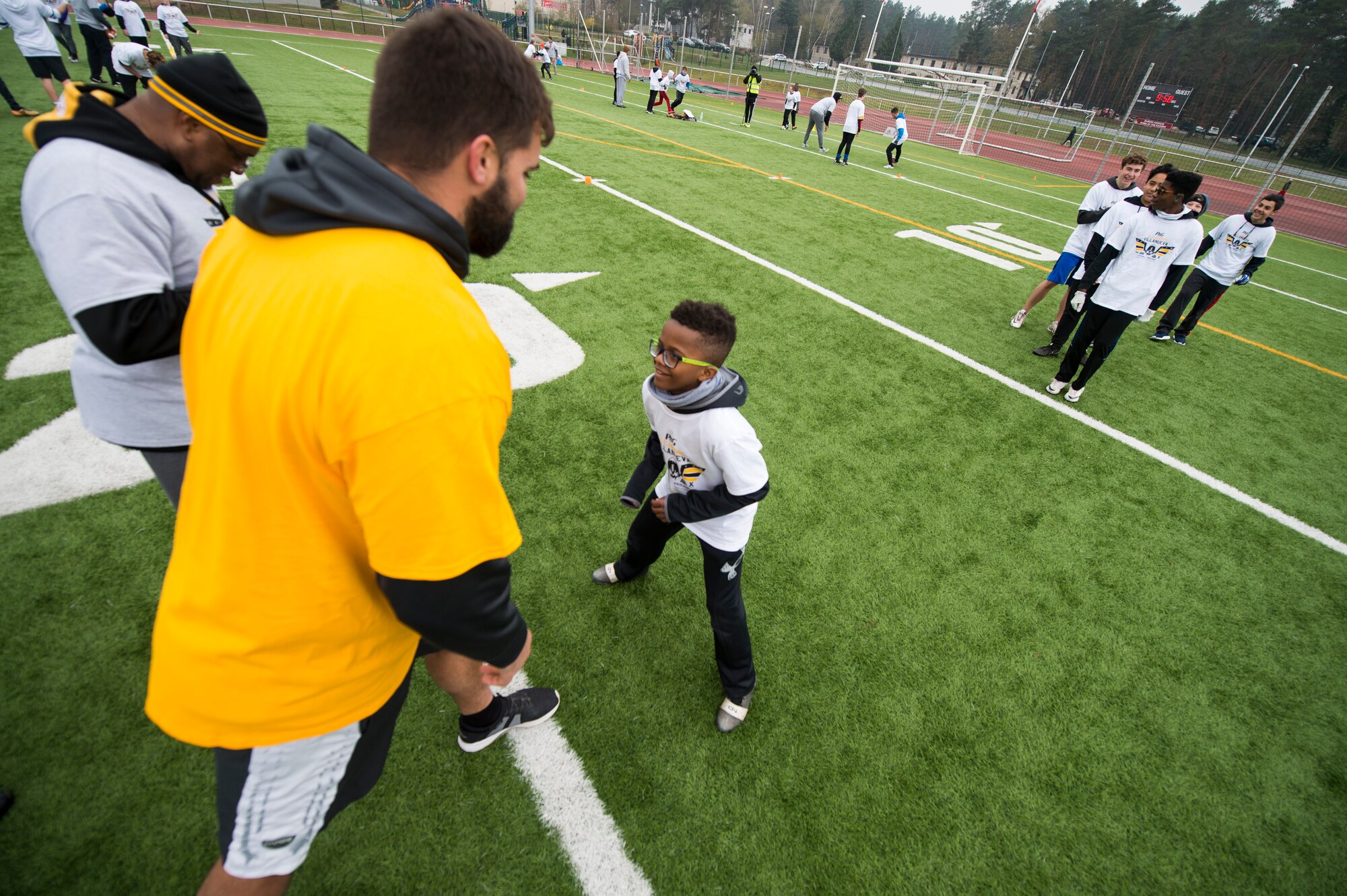 Alejandro Villanueva, Pittsburgh Steelers offensive lineman, prepares to run a route against one of his camp attendees while practicing offensive drills during his football camp at Kaiserslautern High School on Vogelweh Military Complex, Germany, April 14, 2019. Villanueva, a former U.S. Army captain, hosted his first overseas football camp here this year. (U.S. Air Force photo by Staff Sgt. Jonathan Bass)