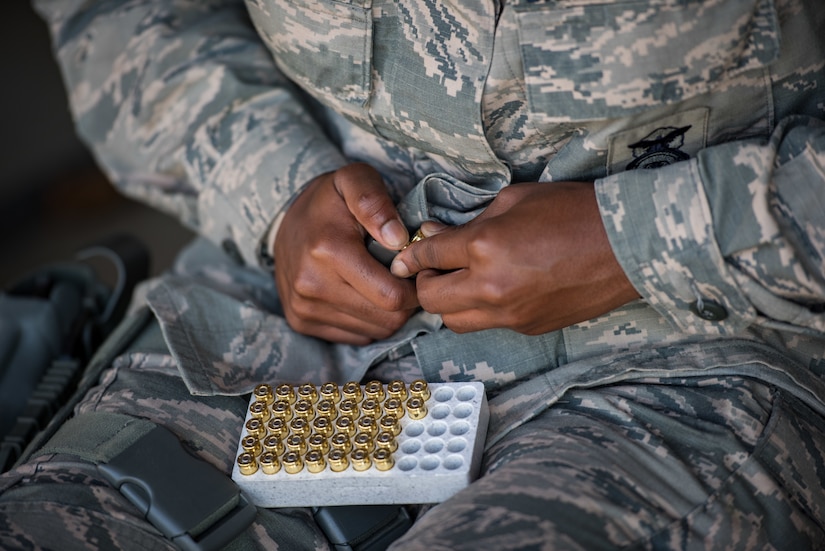 A U.S. Air Force Airman assigned to the 633rd Security Forces Squadron loads an M-9 Berretta during a field training exercise at Joint Base Langley-Eustis, Virginia, April 11, 2019.