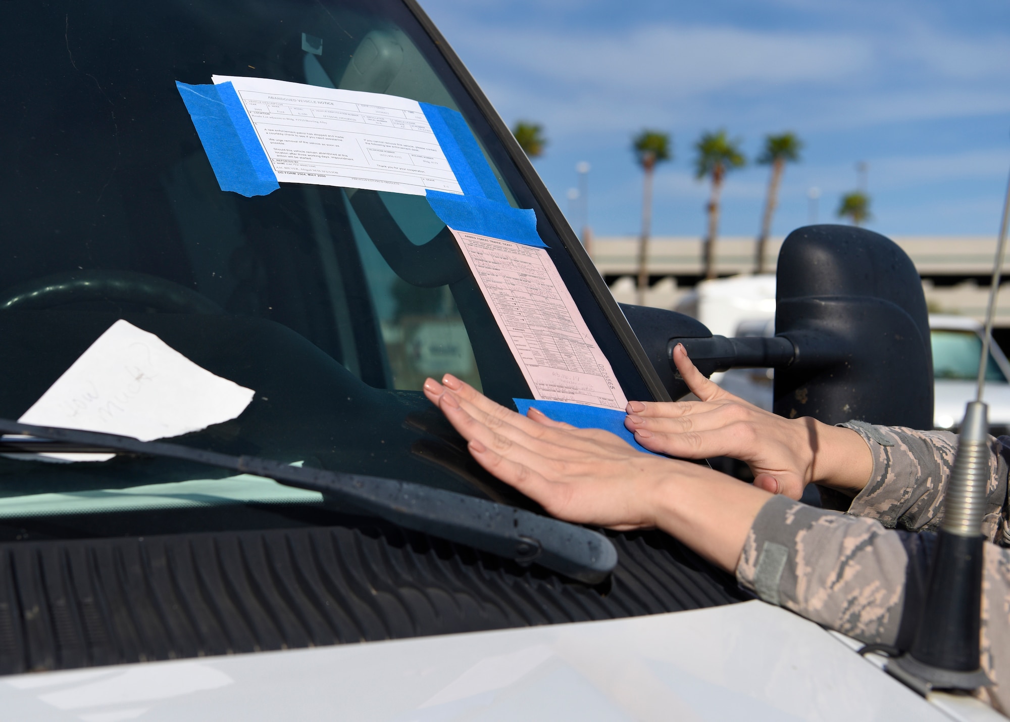 Airman 1st Class Abigail Biever, 56th Security Forces Squadron team member, leaves a vehicle notice and ticket on an abandoned vehicle April 11, 2019, at Luke Air Force Base Ariz.
