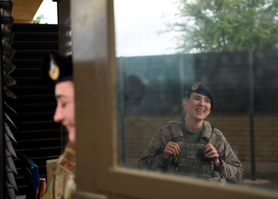 Airman 1st Class Abigail Biever, 56th Security Forces Squadron team member, converses with a defender in the vehicle inspection pit April 11, 2019, at Luke Air Force Base Ariz.