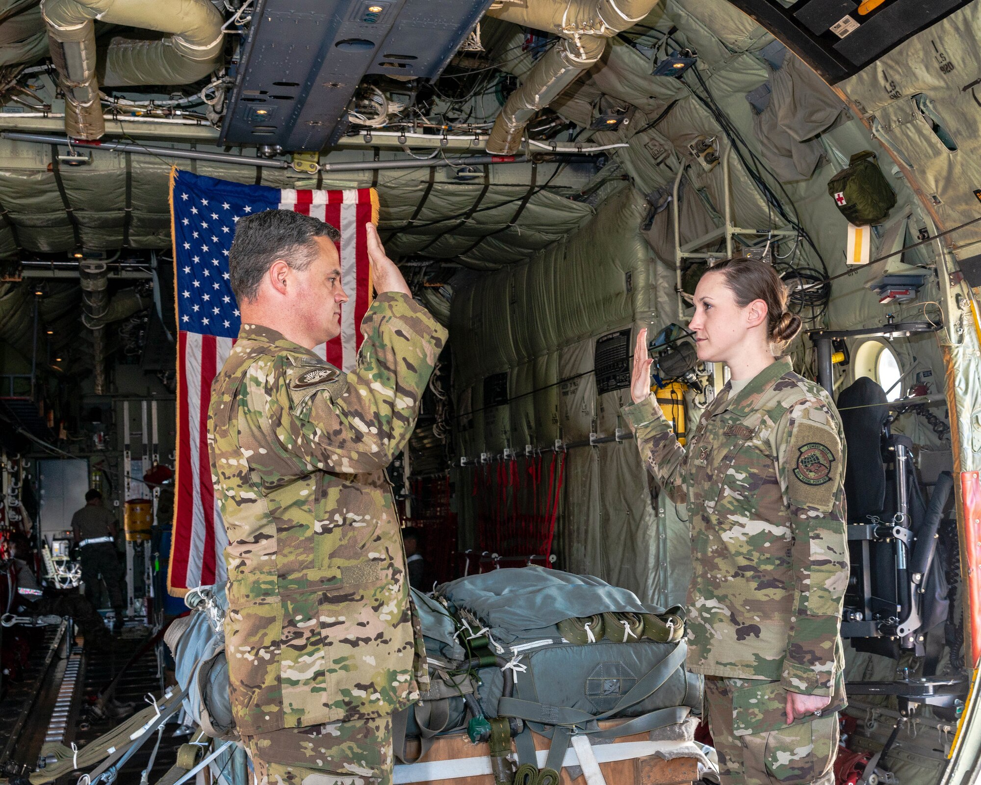 Tech. Sgt. Alex Erwin, 96th Aerial Port Squadron air transportation specialist, reenlists in the cargo area of a C-130J on April 15, 2019.