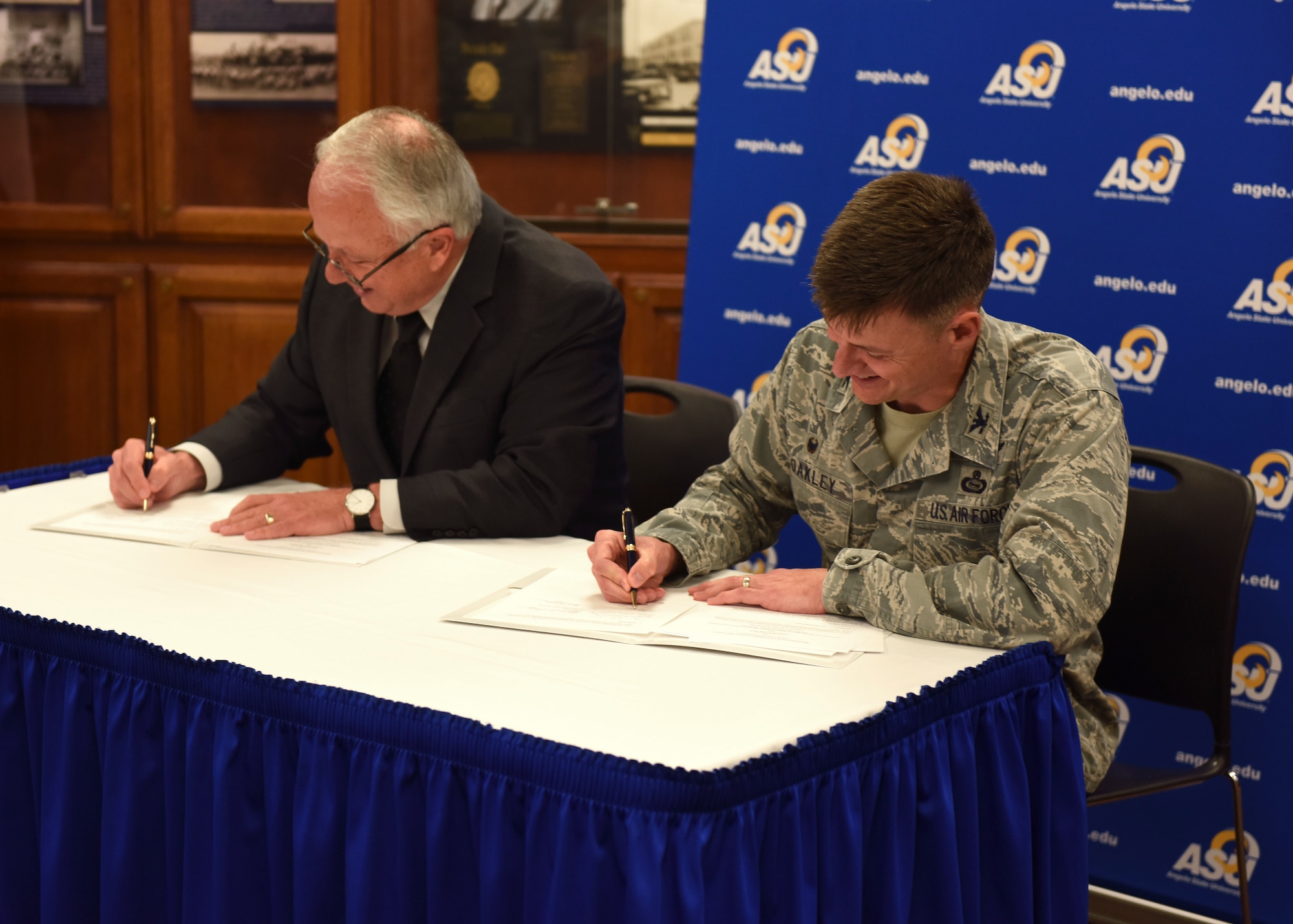 Angelo State University President, Dr. Brian May and U.S. Air Force Col. Thomas Coakley, 17th Training Group commander, sign a Memorandum of Understanding, at ASU, Texas, April 15, 2019. The MOUR allows 14N professionals to transfer 12 credit hours toward two master’s degree through Angelo State University (U.S. Air Force photo by Airman 1st Class Zachary Chapman/Released)
