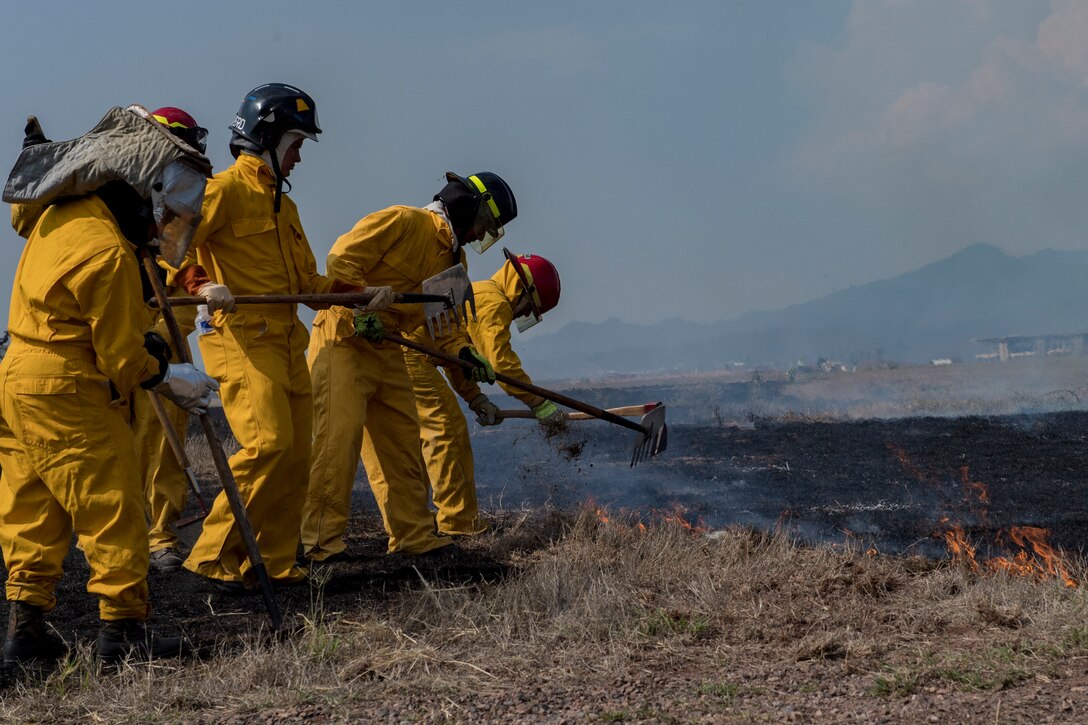 Central American firefighters plow the ground to contain a wildlands fire during the Central America Sharing Mutual Operational Knowledge and Experiences (CENTAM SMOKE) exercise, April 11, 2019, at Soto Cano Air Base, Honduras. CENTAM SMOKE brought together firefighters from Honduras, Costa Rica, Belize, Guatemala and El Salvador to train with U.S. Air Force members as well as develop bonds and understandings of one another’s culture with team building exercises. The weeklong training included aircraft and structural fires, vehicle extrication, and a firefighter combat challenge. (U.S. Air Force photo by Staff Sgt. Eric Summers Jr.)