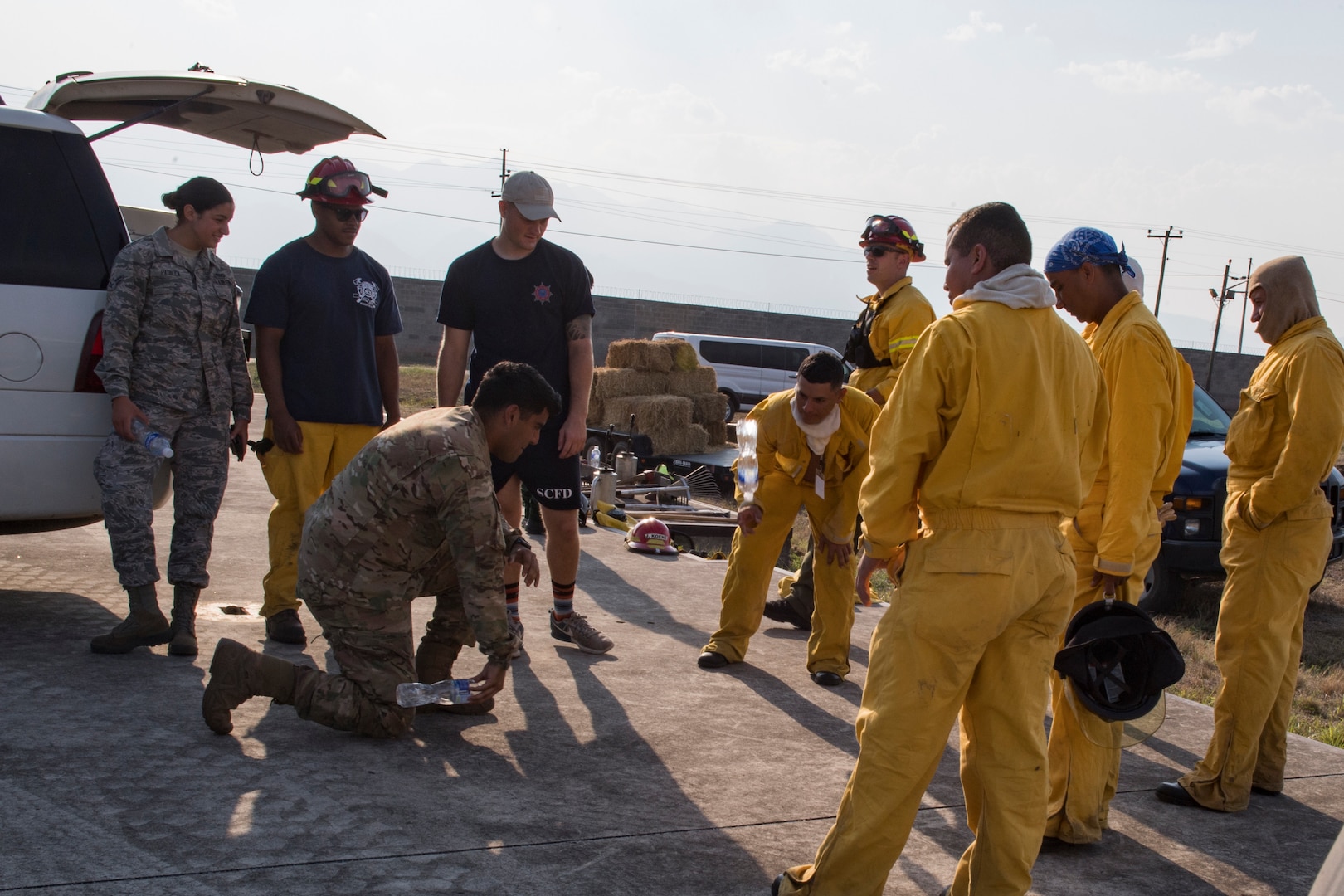 A group of U.S. Air Force and Central American firefighters relax after extinguishing a wildlands fire during the Central America Sharing Mutual Operational Knowledge and Experiences (CENTAM SMOKE) exercise, April 11, 2019, at Soto Cano Air Base, Honduras. CENTAM SMOKE brought together firefighters from Honduras, Costa Rica, Belize, Guatemala and El Salvador to train with U.S. Air Force members as well as develop bonds and understandings of one another’s culture with team building exercises. The weeklong training included aircraft and structural fires, vehicle extrication, and a firefighter combat challenge. (U.S. Air Force photo by Staff Sgt. Eric Summers Jr.)