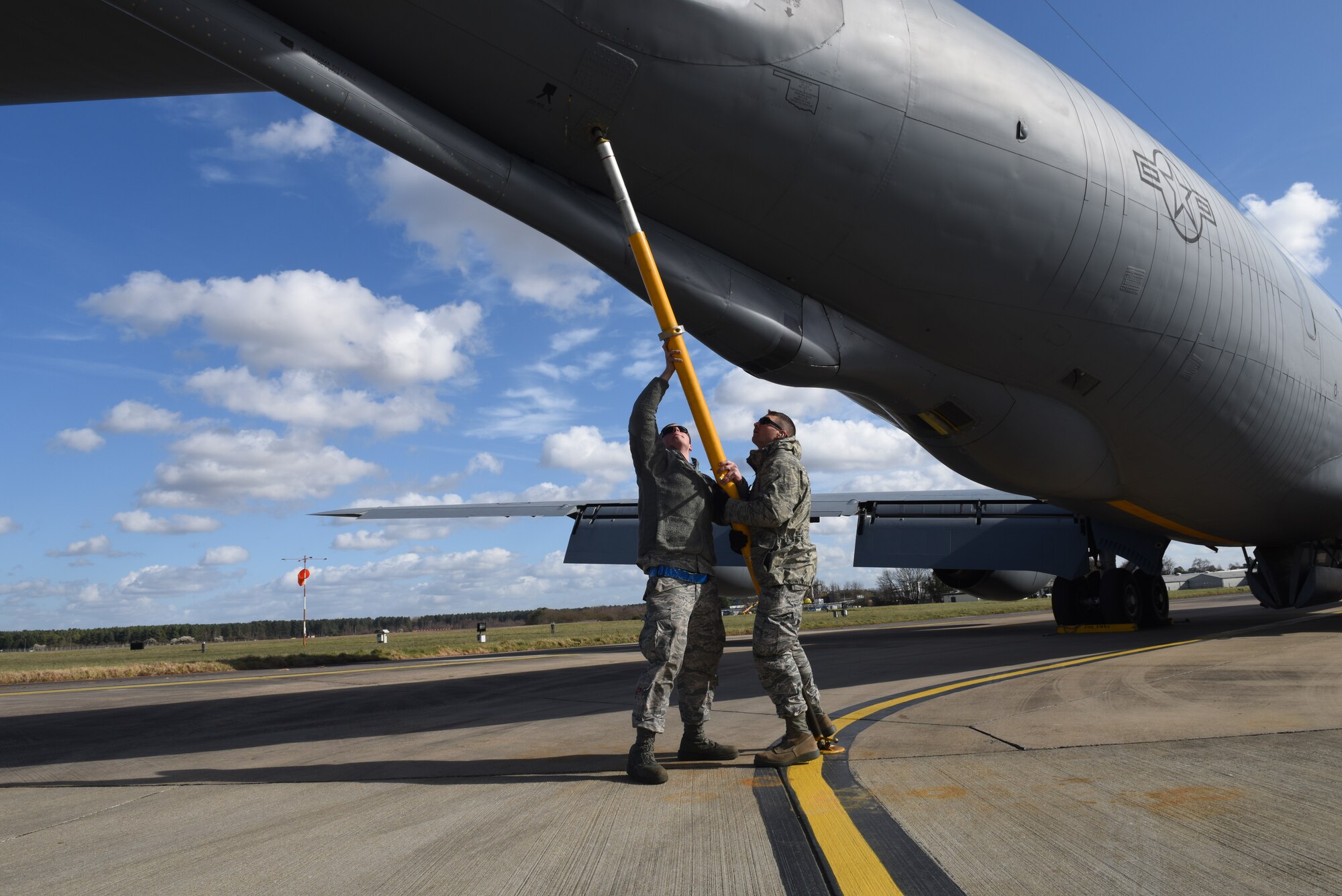 U.S. Air Force Airman 1st Class Brenden Hurston and U.S. Air Force Staff Sgt. Lee Buehrer, 100th Aircraft Maintenance Squadron crew chiefs, install a tail stand on a KC-135 Stratotanker after recovering the aircraft at RAF Mildenhall, England, March 5, 2019. A tail stand is installed on a KC-135 for cargo loading operations or fuel servicing. (U.S. Air Force photo by Senior Airman Luke Milano)