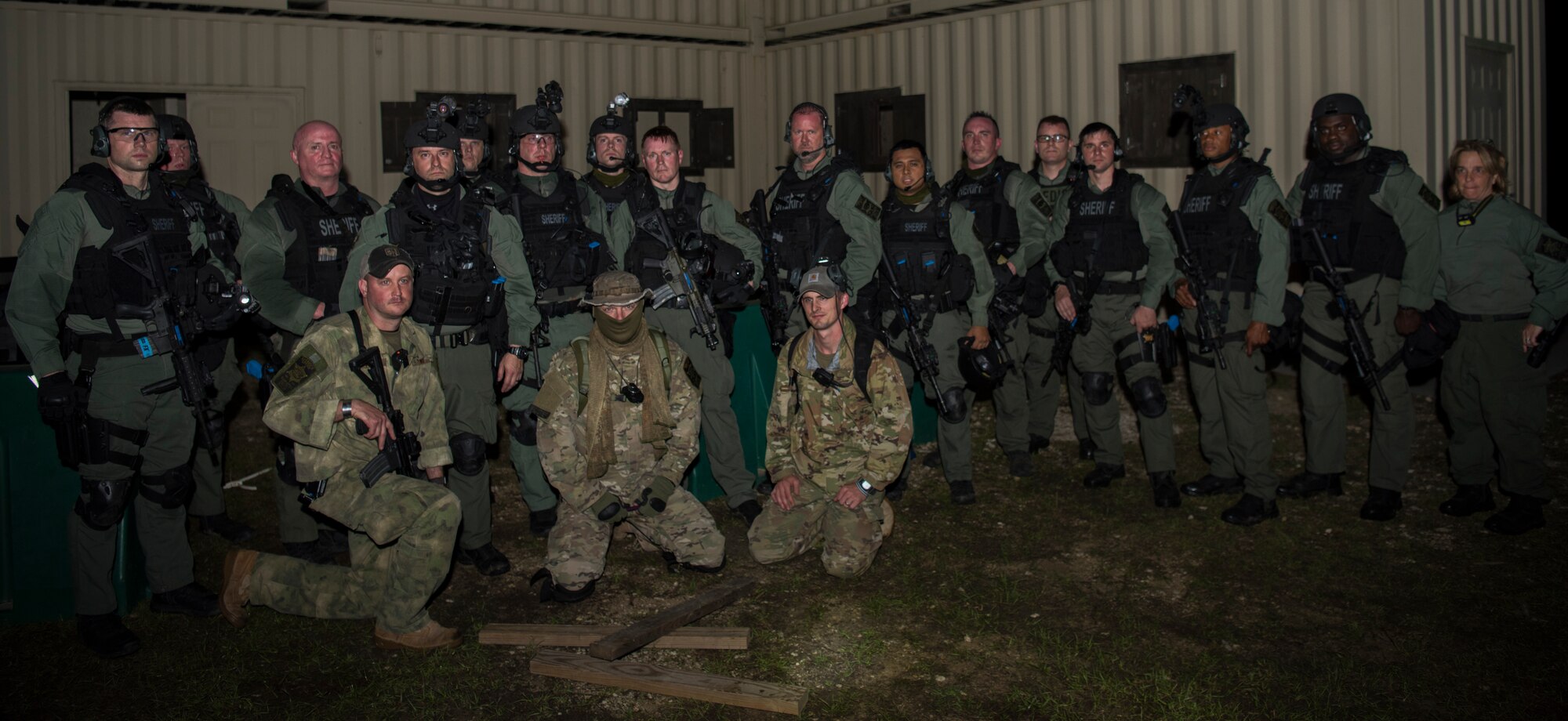 Members of the Charleston County S.W.A.T. team gather in front of a shoot house during a joint training exercise with Citadel cadets and the 628th Security Forces Squadron April 12, 2019, on Naval Weapons Station Charleston, Joint Base Charleston, S.C.