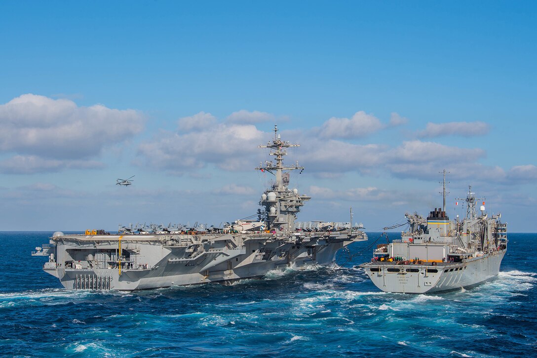 Two ships conduct a replenishment at sea.