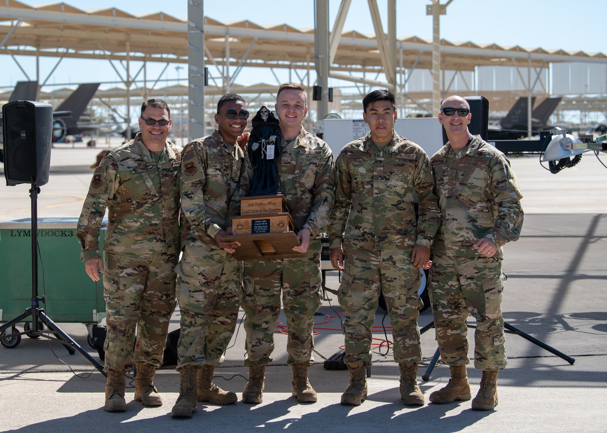 The 61st Aircraft Maintenance Unit load crew team accepts a trophy after winning the 1st Quarter Load Crew Competition, April 11, 2019, at Luke Air Force Base, Ariz.
