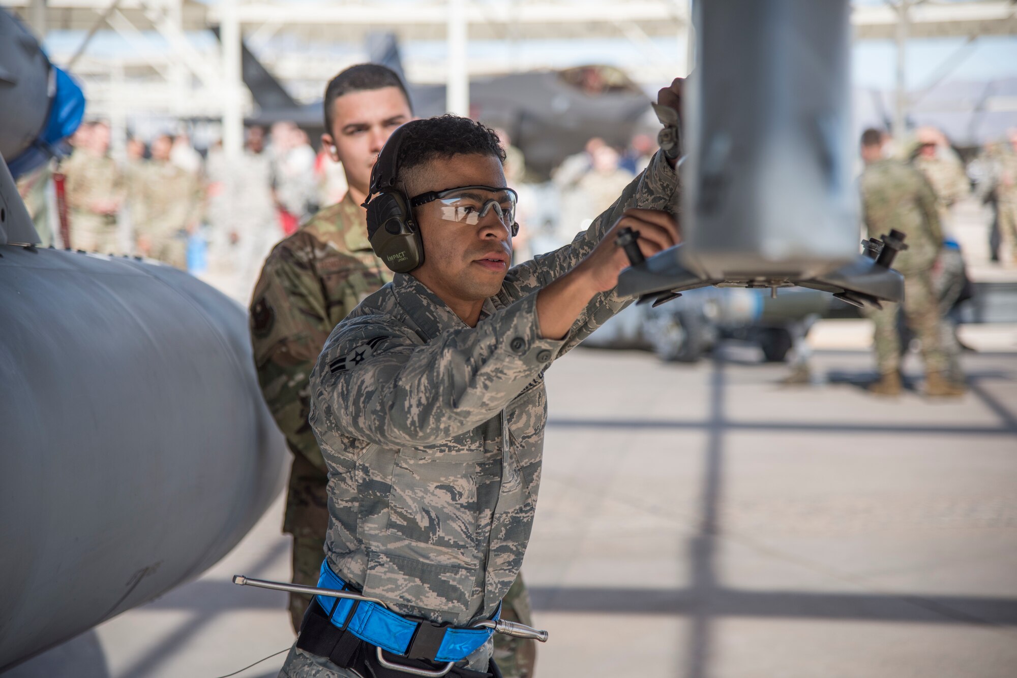 Airman 1st Class Jonas Scrivens, 309th Aircraft Maintenance Unit weapons load crew member, prepares an F-16 Fighting Falcon for the loading of inert munitions during the 1st Quarter Load Crew Competition, April 11, 2019, at Luke Air Force Base, Ariz.