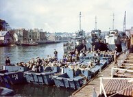 Coast Guard Flotilla 10 tied up in the background along
with British landing craft, prepare to sail the English Channel and invade Nazi-occupied France. These landing craft landed U.S. troops on Omaha Beach.