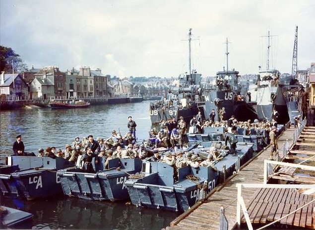 Coast Guard Flotilla 10 tied up in the background along
with British landing craft, prepare to sail the English Channel and invade Nazi-occupied France. These landing craft landed U.S. troops on Omaha Beach.