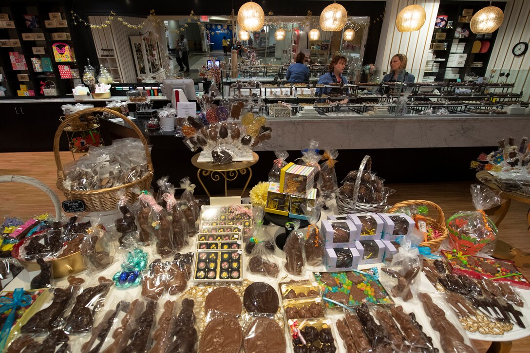 Chocolates cover the counters of a shop.