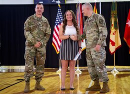 Sgt. 1st Class Kerrilee Case, 1st Theater Sustainment Command, poses for a photograph with Maj. Gen. John R. Evans, commanding general, and Command Sgt. Major. Mario Terenas, senior enlisted advisor, both with the U.S. Army Cadet Command, April 10, 2019 at Fort Knox, Ky., during the post’s Outstanding Volunteer of the Year Recognition Ceremony. Evans and Terenas presented Case with an award for being named the Military Volunteer of the Year.