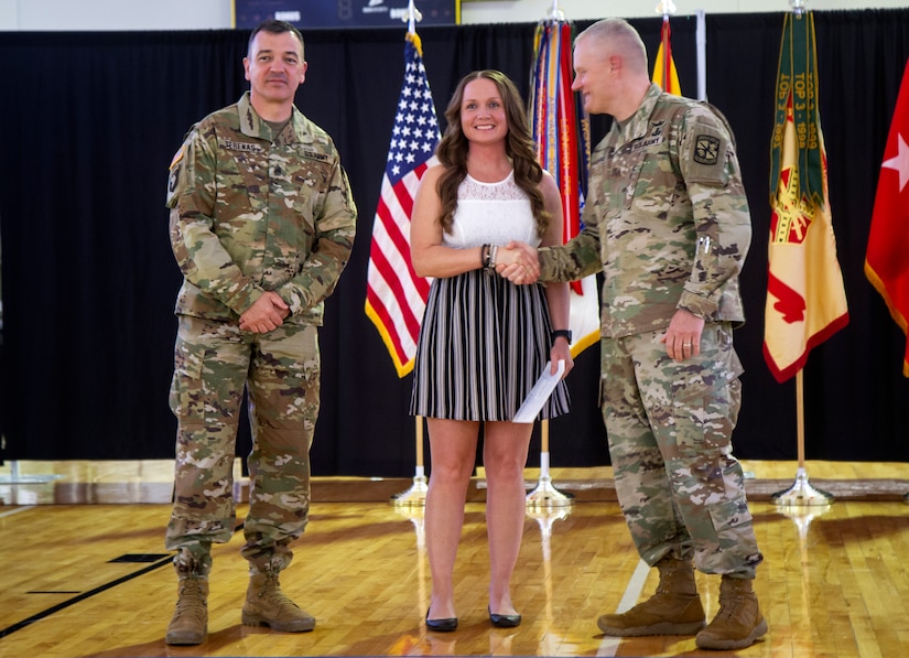 Sgt. 1st Class Kerrilee Case, 1st Theater Sustainment Command, poses for a photograph with Maj. Gen. John R. Evans, commanding general, and Command Sgt. Major. Mario Terenas, senior enlisted advisor, both with the U.S. Army Cadet Command, April 10, 2019 at Fort Knox, Ky., during the post’s Outstanding Volunteer of the Year Recognition Ceremony. Evans and Terenas presented Case with an award for being named the Military Volunteer of the Year.