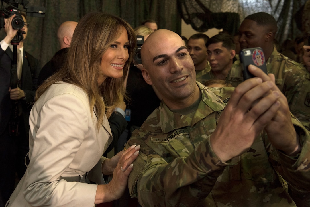 Melania Trump poses for a selfie with a soldier.
