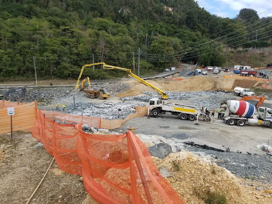 Heavy equipment moving rocks at Guajataca Dam, Puerto Rico