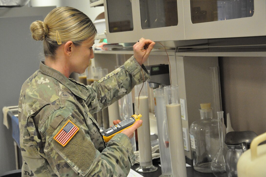 Staff Sgt. Kyla Stewart, a technical engineer in the Far East District (FED) materials testing laboratory learns the correct testing techniques from FED's material engineer, Song, Un-ho, April 11 at the Far East District headquarters, Camp Humphreys, Korea.