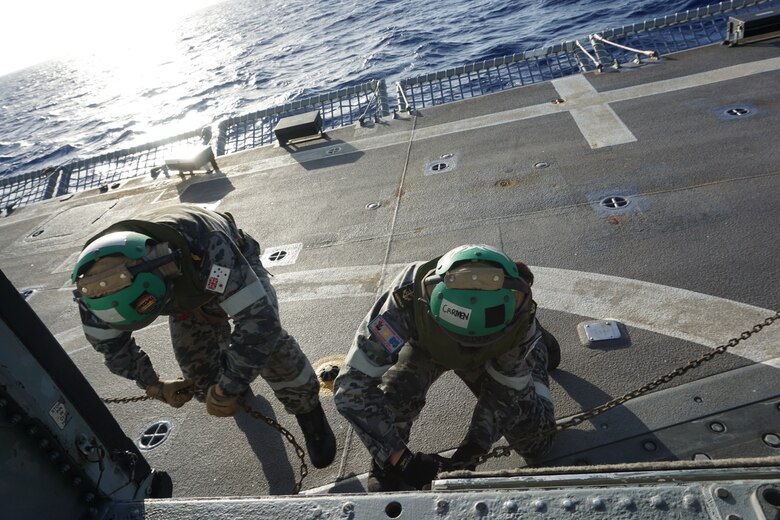 An MH-60S Sea Hawk helicopter, assigned to the "Island Knights" of Helicopter Sea Combat Squadron (HSC) 25 prepares to land aboard Royal Australian Navy guided-missile frigate HMAS Melbourne (FFG 05) to conduct deck landing qualification.  HSC-25 provides a multi-mission rotary wing capability for units in the U.S. 7th Fleet area of operations and maintains a Guam-based 24-hour search-and-rescue and medical evacuation capability, directly supporting U.S. Coast Guard and Joint Region Marianas. HSC-25 is the Navy’s only forward-deployed MH-60S expeditionary squadron.