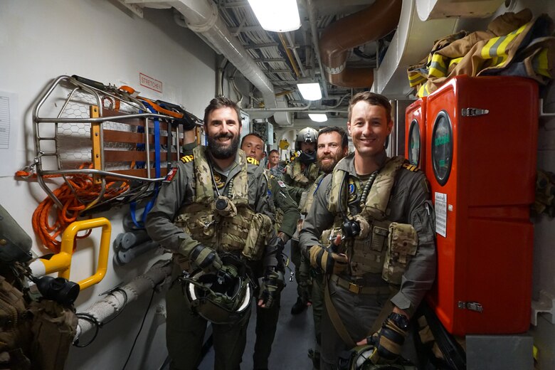 Two crew members from Royal Australian Navy guided-missile frigate HMAS Melbourne (FFG 05) prepare for a familiarization flight in an MH-60S Sea Hawk helicopter, assigned to the "Island Knights" of Helicopter Sea Combat Squadron (HSC) 25. HSC-25 provides a multi-mission rotary wing capability for units in the U.S. 7th Fleet area of operations and maintains a Guam-based 24-hour search-and-rescue and medical evacuation capability, directly supporting U.S. Coast Guard and Joint Region Marianas. HSC-25 is the Navy’s only forward-deployed MH-60S expeditionary squadron.