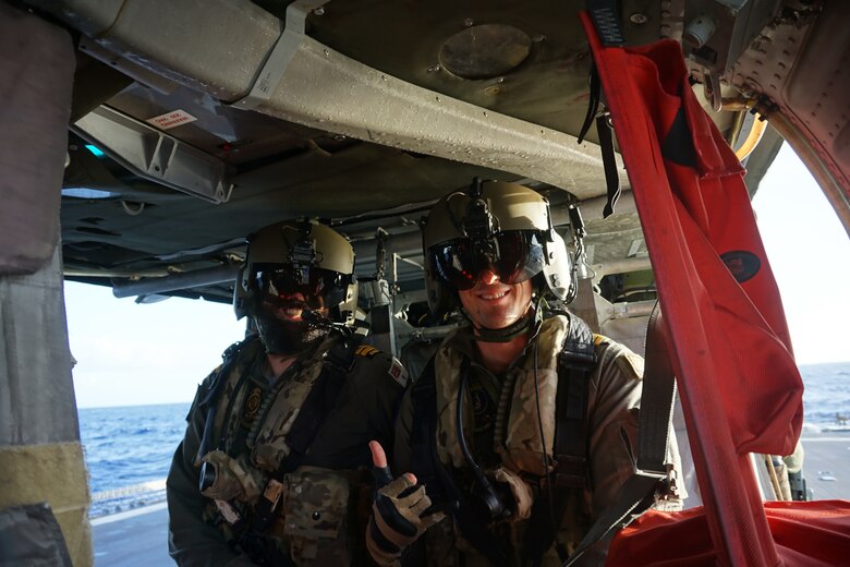 Senior leaders from Royal Australian Navy guided-missile frigate HMAS Melbourne (FFG 05) and Helicopter Sea Combat Squadron (HSC) 25 pause for a photo during visit conducted in conjunction with deck landing qualifications between the two units.  HSC-25 provides a multi-mission rotary wing capability for units in the U.S. 7th Fleet area of operations and maintains a Guam-based 24-hour search-and-rescue and medical evacuation capability, directly supporting U.S. Coast Guard and Joint Region Marianas. HSC-25 is the Navy’s only forward-deployed MH-60S expeditionary squadron.